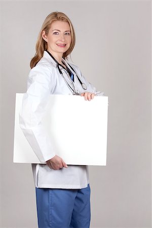 simsearch:400-05745246,k - blond female doctor posing on light grey background Photographie de stock - Aubaine LD & Abonnement, Code: 400-06919819