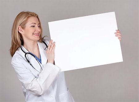 simsearch:400-05745246,k - blond female doctor posing on light grey background Photographie de stock - Aubaine LD & Abonnement, Code: 400-06919820