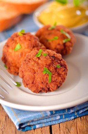 meat balls with mustard on white dish on wooden backgrounds Stock Photo - Budget Royalty-Free & Subscription, Code: 400-06912692