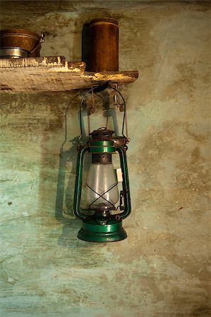 Antique oil lamp with clipping path hanging on wall with matchstick Fotografie stock - Microstock e Abbonamento, Codice: 400-06912742