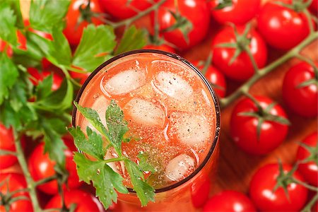 Blood mary alcohol cocktail (top view) with cherry tomatos and celery on background Stock Photo - Budget Royalty-Free & Subscription, Code: 400-06913401