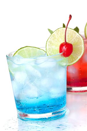 Two cocktails with lime slice and maraschino. Isolated on white background Stock Photo - Budget Royalty-Free & Subscription, Code: 400-06913517