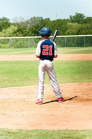 Teen baseball boy looking at coach while at bat. Stock Photo - Budget Royalty-Free & Subscription, Code: 400-06924850