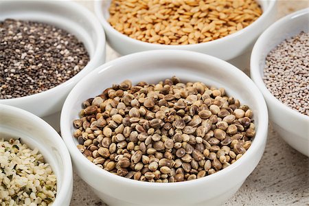 hemp seeds in a white ceramic bowl among other healthy seeds Stock Photo - Budget Royalty-Free & Subscription, Code: 400-06925261