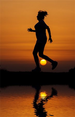 silhouettes of running black girl - Silhouette woman running against orange sunset with reflection in water Stock Photo - Budget Royalty-Free & Subscription, Code: 400-06926826