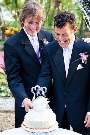 Two happy grooms cutting the cake at their wedding. Stock Photo - Budget Royalty-Free & Subscription, Code: 400-06926918