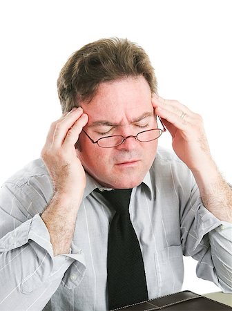 simsearch:400-05021851,k - Closeup of a businessman rubbing his temples to relieve a headache.  White background. Foto de stock - Super Valor sin royalties y Suscripción, Código: 400-06926911