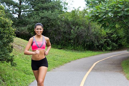 Smiling young woman running for fitness Photographie de stock - Aubaine LD & Abonnement, Code: 400-06927467