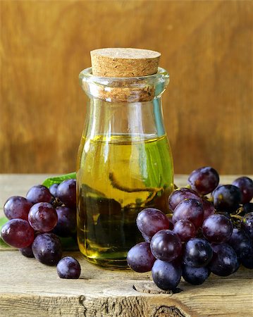 bottle with grape seed oil on a wooden table Stock Photo - Budget Royalty-Free & Subscription, Code: 400-06927667
