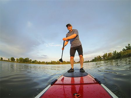 simsearch:400-07795226,k - mature male paddler enjoying workout on stand up paddleboard (SUP), calm lake in Colorado, summer Foto de stock - Royalty-Free Super Valor e Assinatura, Número: 400-06927800