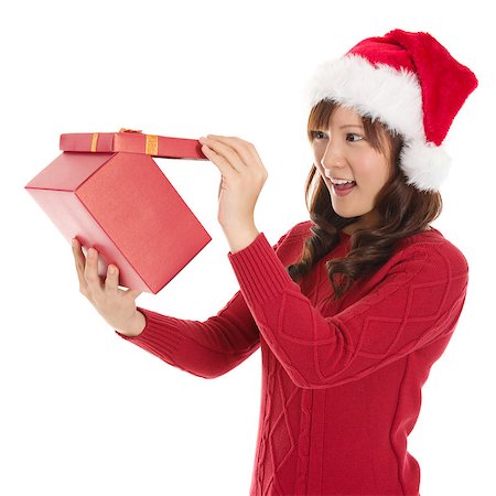 simsearch:400-06477682,k - Christmas Gift - Asian woman opening gift surprised and happy, Young beautiful smiling woman in Santa hat. Funny cute photo of Asian woman isolated on white background Stock Photo - Budget Royalty-Free & Subscription, Code: 400-06927998
