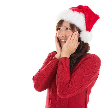 simsearch:400-06477682,k - Daydreaming Asian Christmas woman wearing santa hat. Christmas woman portrait of a cute, beautiful smiling Asian Chinese / Japanese model. Isolated on white background. Stock Photo - Budget Royalty-Free & Subscription, Code: 400-06927991