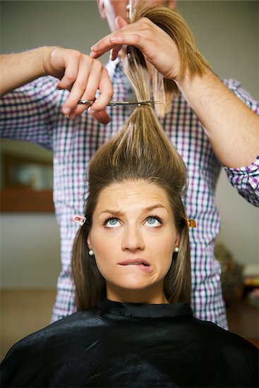 female client in hairdresser shop uncertain about cutting hair and biting lips Stock Photo - Royalty-Free, Artist: diego_cervo, Image code: 400-06928119