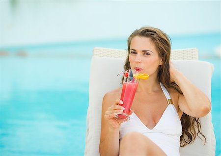 sunbed and cocktail - Young woman laying on chaise-longue and drinking cocktail Stock Photo - Budget Royalty-Free & Subscription, Code: 400-06928304