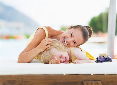Happy mother and baby playing at poolside Stock Photo - Budget Royalty-Free & Subscription, Code: 400-06928317