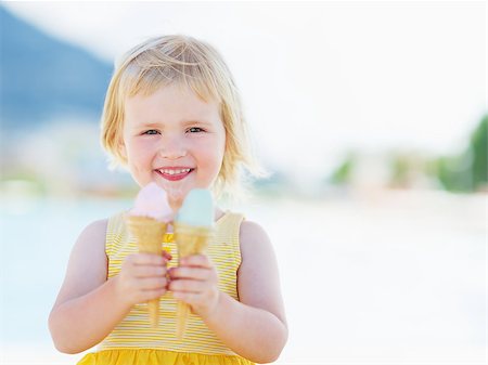 summer ice cream child - Smiling baby eating two ice cream horns Stock Photo - Budget Royalty-Free & Subscription, Code: 400-06928326