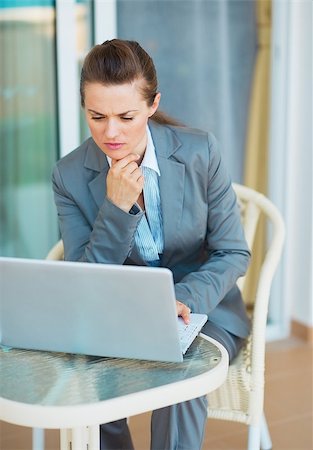 simsearch:400-04287211,k - Thoughtful business woman looking on laptop on terrace Stock Photo - Budget Royalty-Free & Subscription, Code: 400-06928332