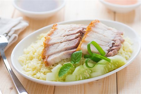 pig roast - Siu Yuk or sliced Chinese boneless roast pork with crispy skin, serve with steamed rice. Hong Kong Chinese cuisine. Stock Photo - Budget Royalty-Free & Subscription, Code: 400-06928971