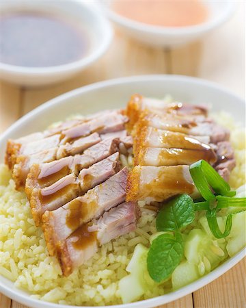 pig roast - Siu Yuk or sliced Chinese boneless roast pork with crispy skin, serve with steamed rice. Singapore Chinese cuisine. Stock Photo - Budget Royalty-Free & Subscription, Code: 400-06928972