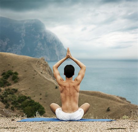 Young Man in Lotus Position near the Ocean. Rear View. Stock Photo - Budget Royalty-Free & Subscription, Code: 400-06929107