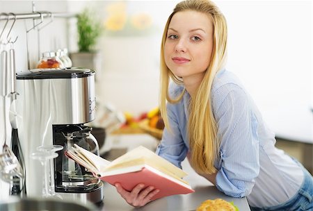 Teenager girl reading book in kitchen Stock Photo - Budget Royalty-Free & Subscription, Code: 400-06929145