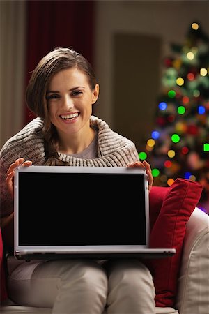 simsearch:400-06419734,k - Happy young woman showing laptop blank screen Stock Photo - Budget Royalty-Free & Subscription, Code: 400-06929637