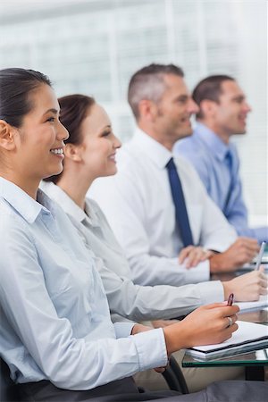 simsearch:400-06929754,k - Cheerful workmates attending presentation in bright office Stockbilder - Microstock & Abonnement, Bildnummer: 400-06929737