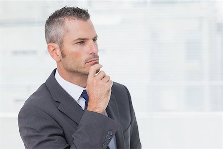 simsearch:400-07275251,k - Pensive businessman in bright office looking away Stock Photo - Budget Royalty-Free & Subscription, Code: 400-06929763