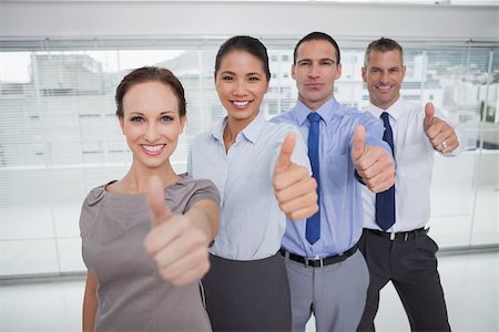 simsearch:400-06929750,k - Smiling work team giving thumbs up in bright office Stock Photo - Budget Royalty-Free & Subscription, Code: 400-06929808