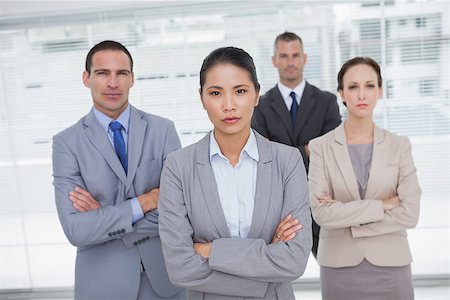 simsearch:400-06929739,k - Serious work team posing crossing arms in bright office Foto de stock - Super Valor sin royalties y Suscripción, Código: 400-06929801