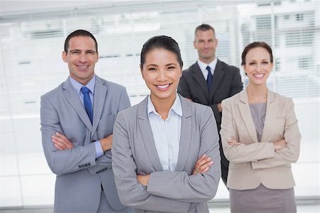simsearch:400-06929750,k - Cheerful work team posing crossing arms in bright office Stock Photo - Budget Royalty-Free & Subscription, Code: 400-06929802