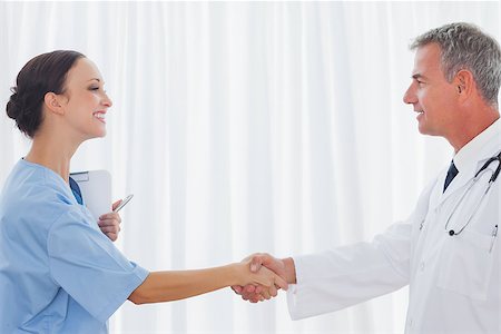 pictures of two nurses shaking hands - Surgeon and doctor shaking hands in bright office Stock Photo - Budget Royalty-Free & Subscription, Code: 400-06929917