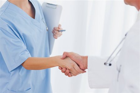 pictures of two nurses shaking hands - Close up on surgeon and doctor shaking hands in bright office Stock Photo - Budget Royalty-Free & Subscription, Code: 400-06929918