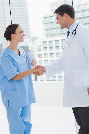 pictures of two nurses shaking hands - Doctor shaking hands with his new surgeon in bright office Stock Photo - Budget Royalty-Free & Subscription, Code: 400-06929925