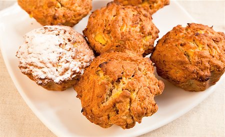 simsearch:400-04831131,k - Fresh baked pumpkin muffins on a plate with sugar icing over one of them. Stock Photo - Budget Royalty-Free & Subscription, Code: 400-06920855