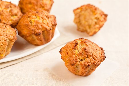 simsearch:400-06429990,k - Fresh baked pumkin muffins with one aside. Stock Photo - Budget Royalty-Free & Subscription, Code: 400-06920853