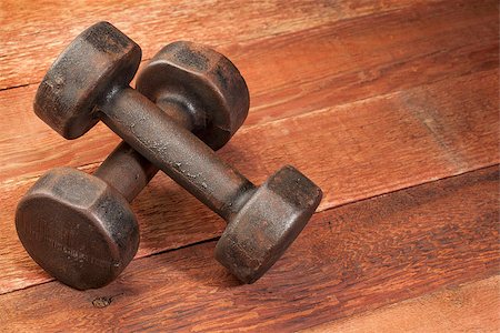 a pair of vintage iron rusty dumbbells on red barn wood background - fitness concept Stock Photo - Budget Royalty-Free & Subscription, Code: 400-06922161