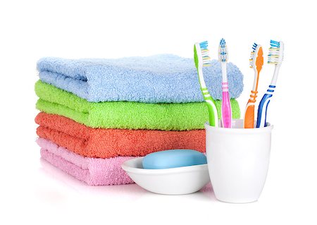 simsearch:400-04789848,k - Four colorful toothbrushes, soap and towels. Isolated on white background Stock Photo - Budget Royalty-Free & Subscription, Code: 400-06922259