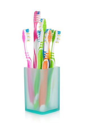 Multicolored toothbrushes in glass. Isolated on white background Stock Photo - Budget Royalty-Free & Subscription, Code: 400-06922275