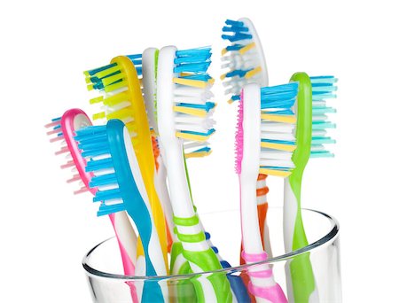 Colorful toothbrushes in glass. Closeup. Isolated on white background Stock Photo - Budget Royalty-Free & Subscription, Code: 400-06922278