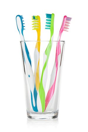 Colorful toothbrushes in glass. Isolated on white background Stock Photo - Budget Royalty-Free & Subscription, Code: 400-06922280