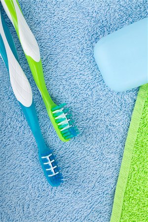 simsearch:400-08133885,k - Toothbrushes and soap over towels. View from above Photographie de stock - Aubaine LD & Abonnement, Code: 400-06922304