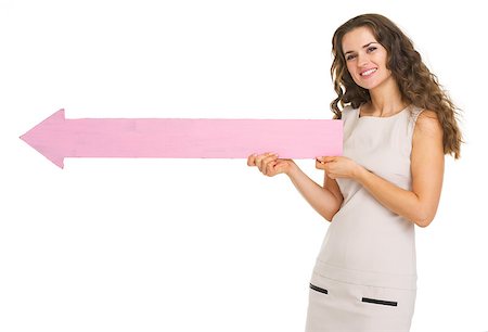 Smiling young woman pointing on copy space with arrow Stock Photo - Budget Royalty-Free & Subscription, Code: 400-06922508