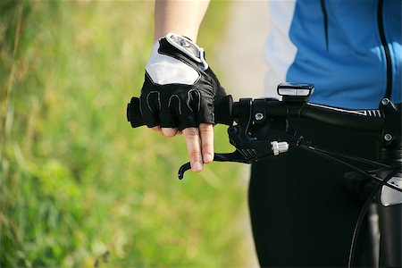 simsearch:400-06922980,k - young woman training on mountain bike and cycling in park. Copy space, cropped view Stock Photo - Budget Royalty-Free & Subscription, Code: 400-06922968