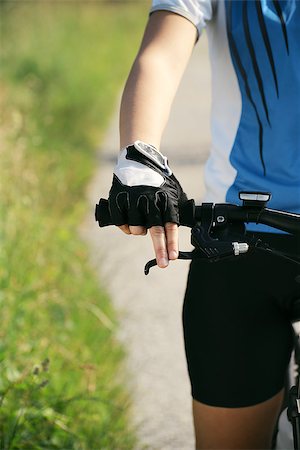 simsearch:400-06922980,k - young woman training on mountain bike and cycling in park. Cropped view Stock Photo - Budget Royalty-Free & Subscription, Code: 400-06922976