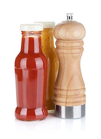 Mustard and ketchup glass bottles with pepper shaker. Isolated on white background Stock Photo - Budget Royalty-Free & Subscription, Code: 400-06923543