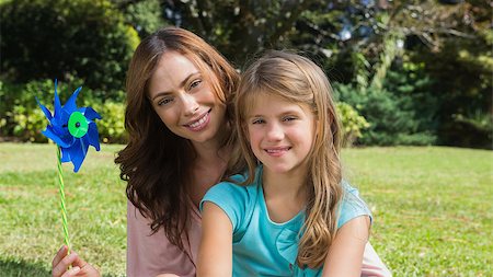 pin wheel family - Happy mother and daughter holding pinwheel smiling at camera in the park Stock Photo - Budget Royalty-Free & Subscription, Code: 400-06934084