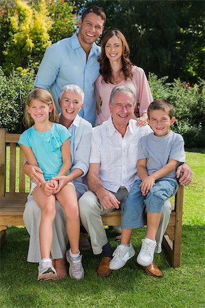 Happy multi generation family sitting in the park on a bench looking at camera Stock Photo - Budget Royalty-Free & Subscription, Code: 400-06934102