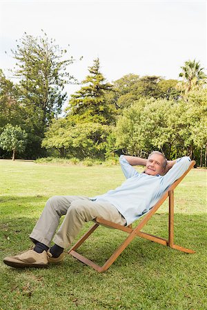Happy mature man resting in sun lounger with hands behind his head in bedroom Stock Photo - Budget Royalty-Free & Subscription, Code: 400-06934178