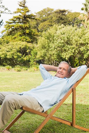 deckchair senior man - Smiling man sitting on sun lounger and looking at camera Stock Photo - Budget Royalty-Free & Subscription, Code: 400-06934179